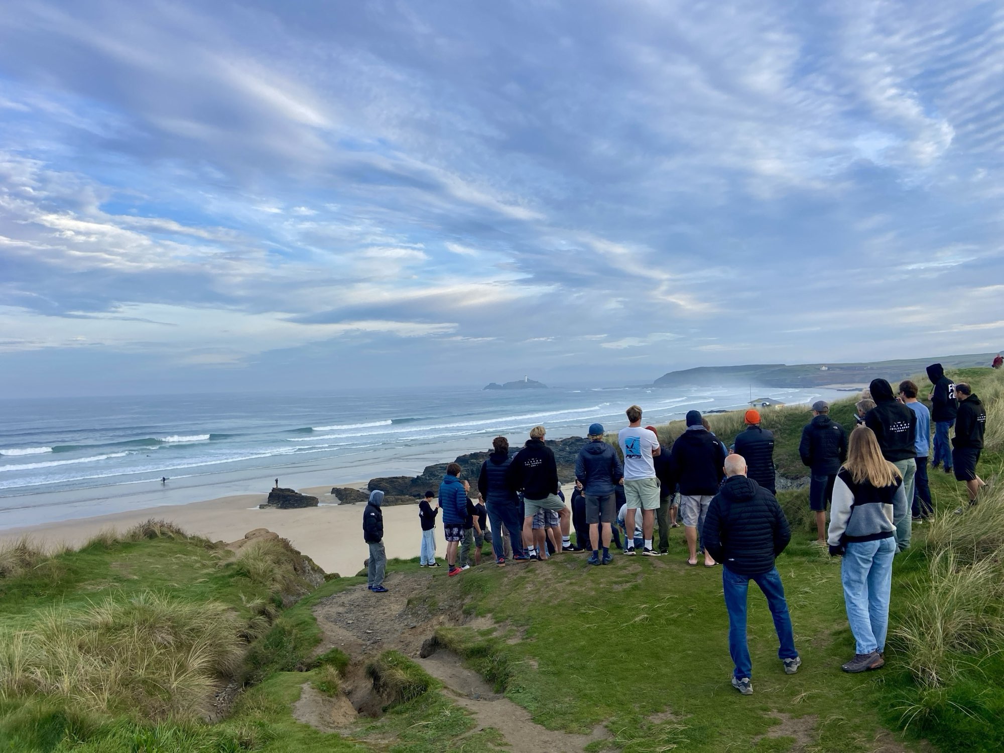 A crowd on the clifftop watching the foiling